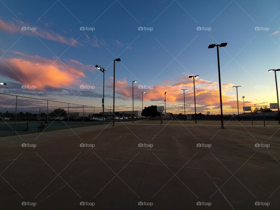 Light towers and clouds create repetition