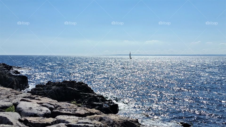 lonely sailing ship on the glittering water