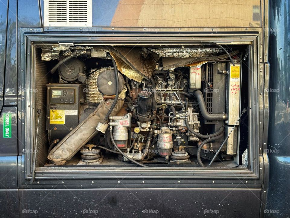 Diesel engine in an open panel on the side of a van