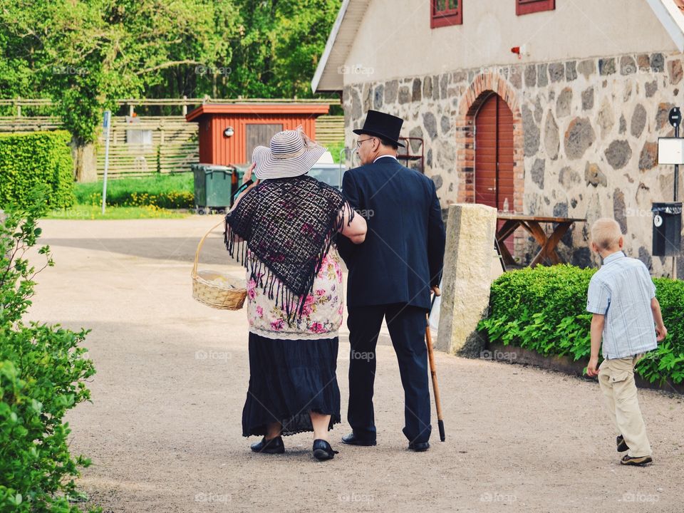 Old people and a child walking in the park