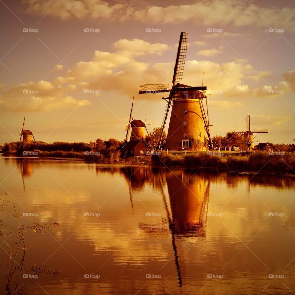 Windmill reflecting on lake