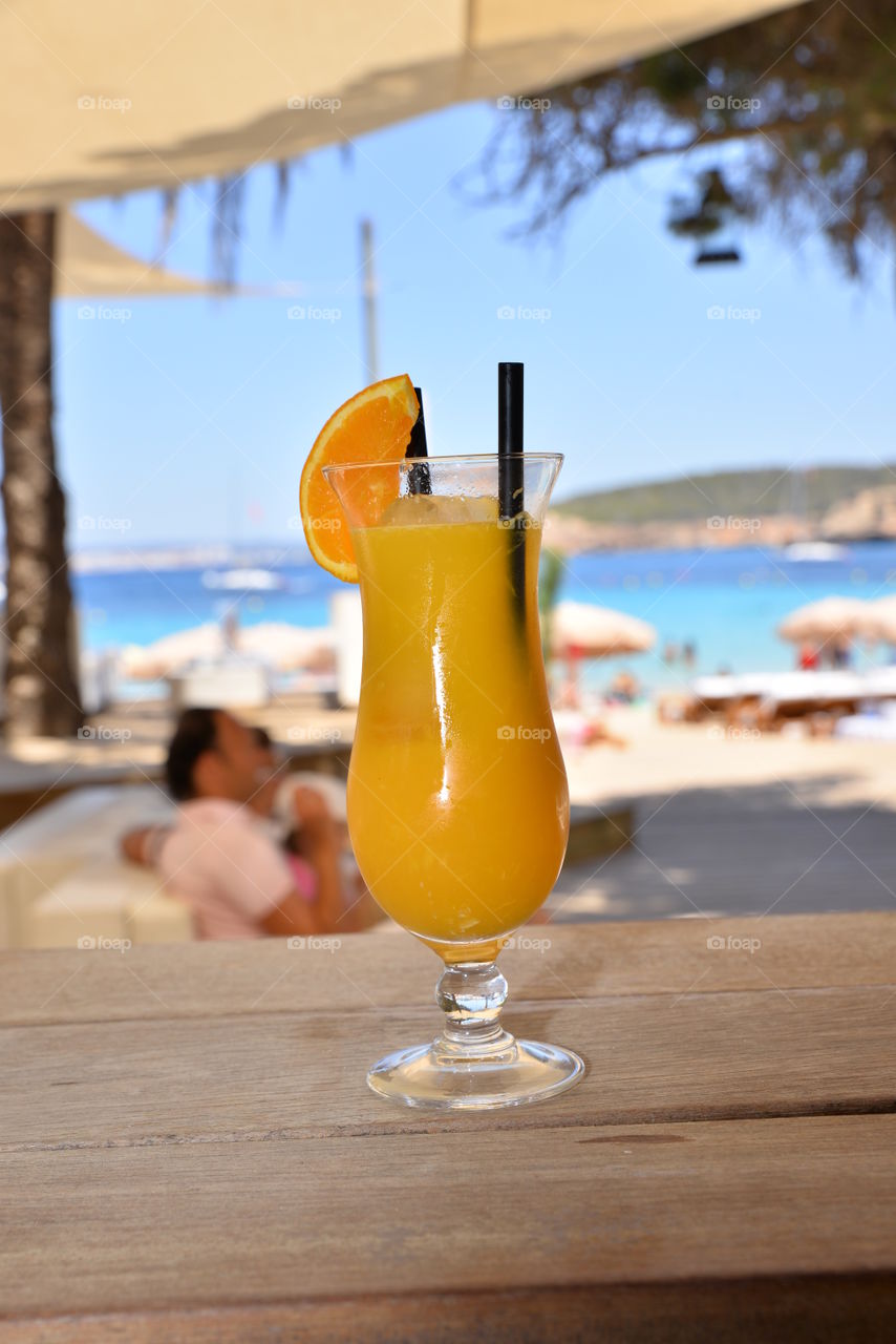 Fresh orange juice on wooden table