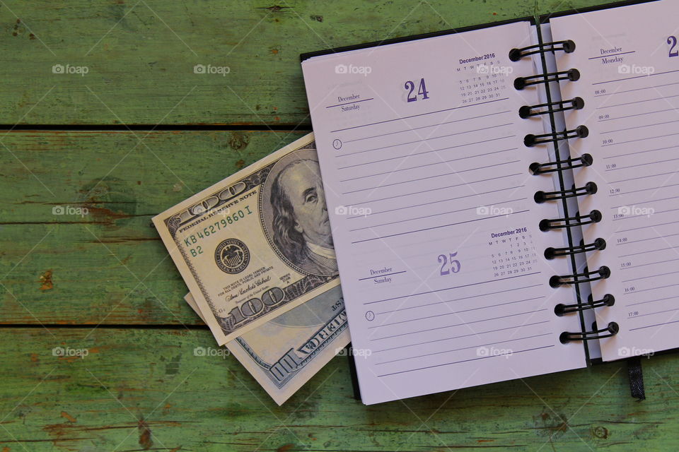 dollars and notebook calendar