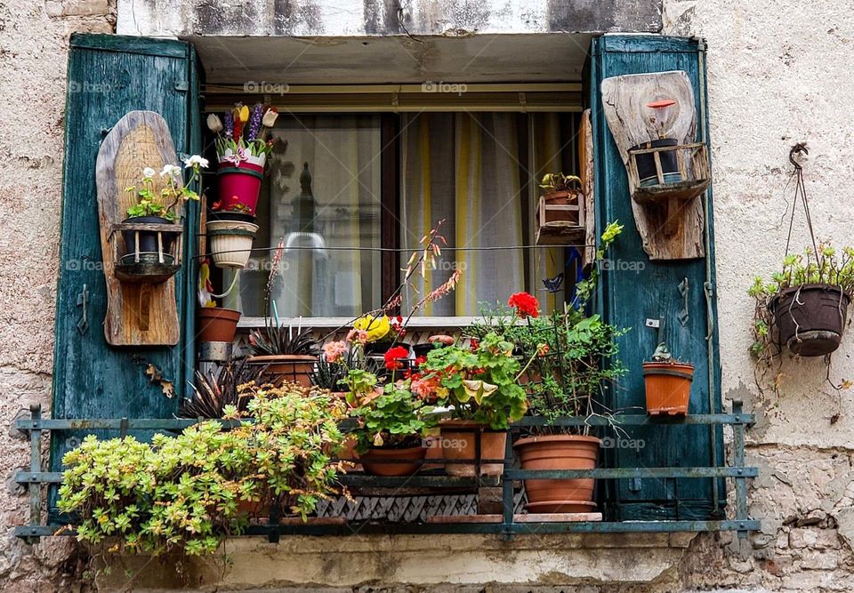 Italians making the best of COVID isolation by dressing up their windows and presenting and more colorful beautiful picture of the outside world