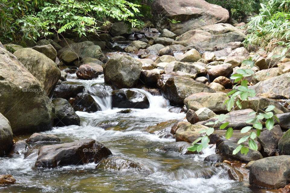 river flowing through srones