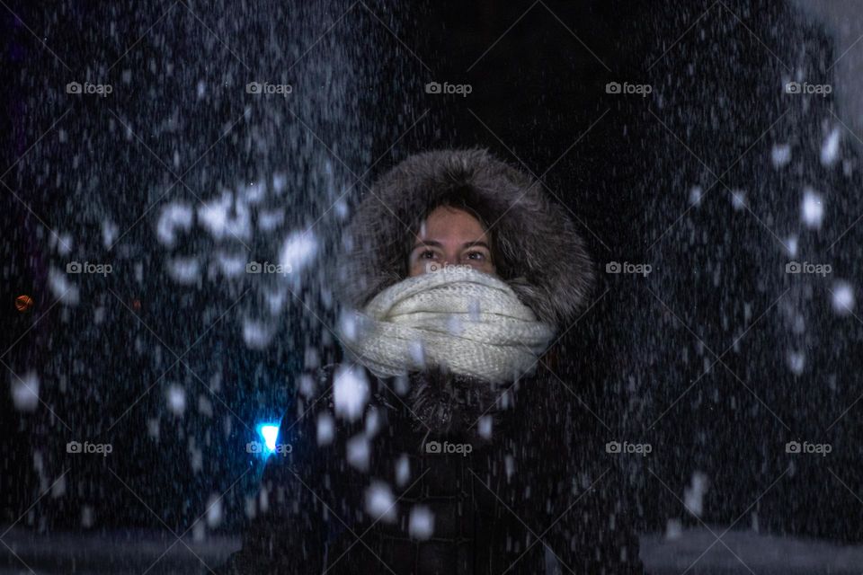 Young woman playing with snow 