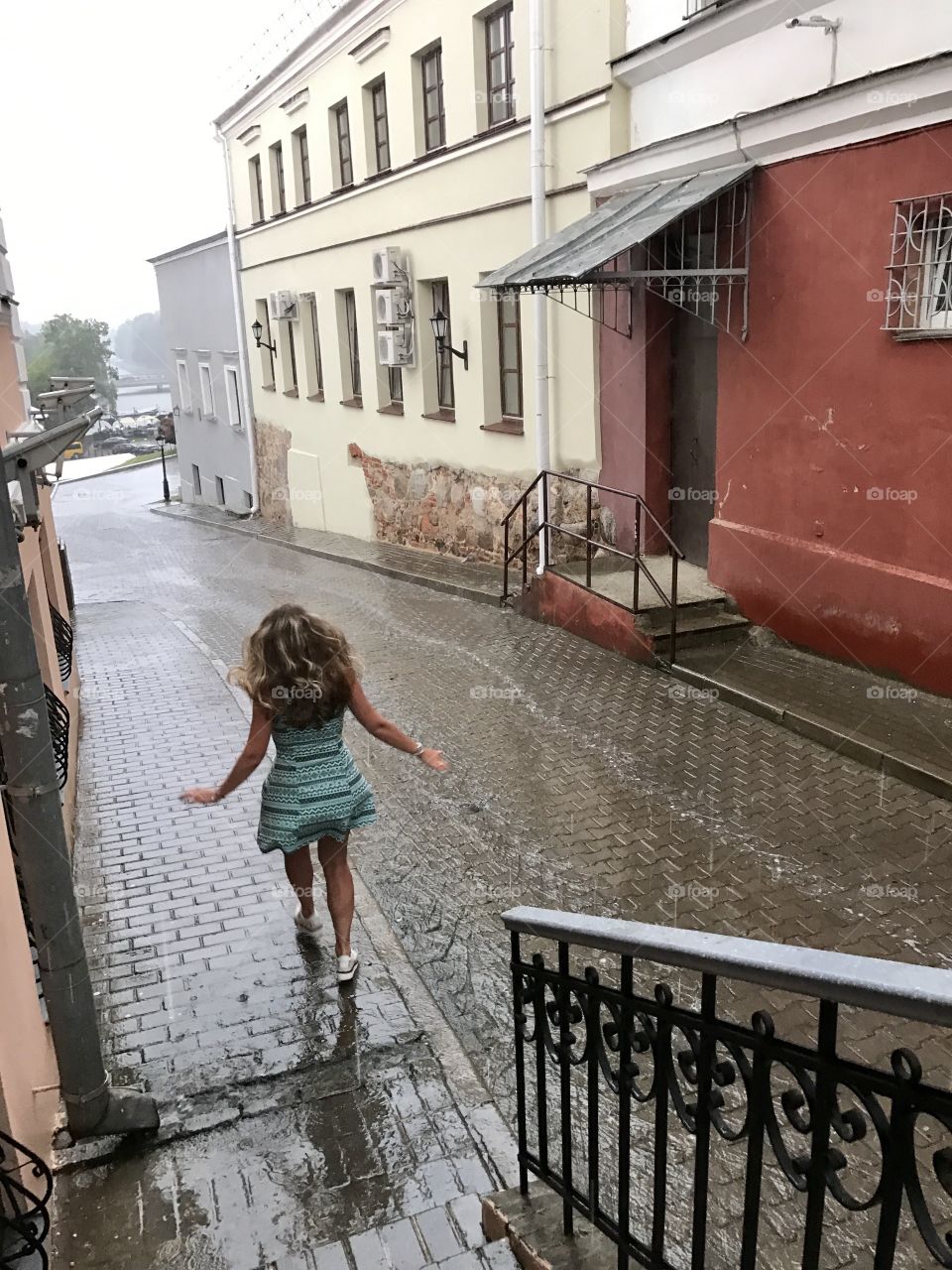 Girl dance under the summer rain 