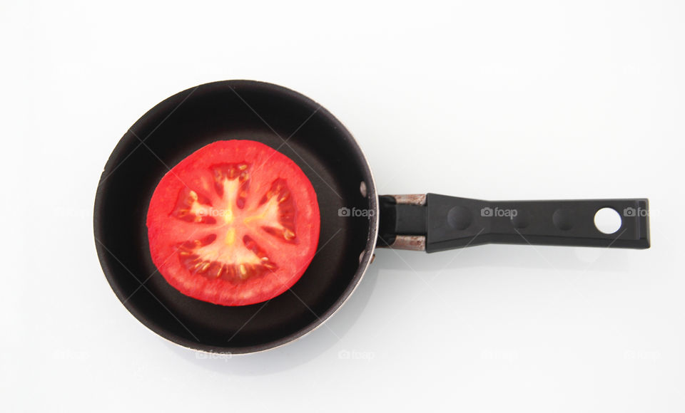 Tomato in the frying pan, healthy food