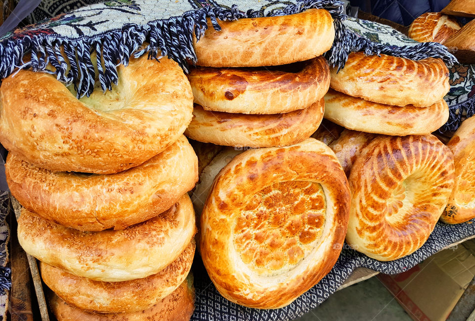 Traditional kyrgiz round bread at the asian market. Round bread on the table at the asian market. Central Asian Tortillas On A Street Counter Near The Tandoor.Orient, asian, indian cuisine
