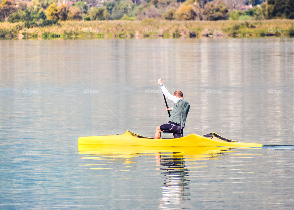 Single Rower At The Lake On A Sunny Day