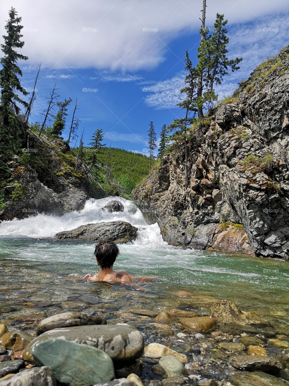 soaking in a mountain river waterfall