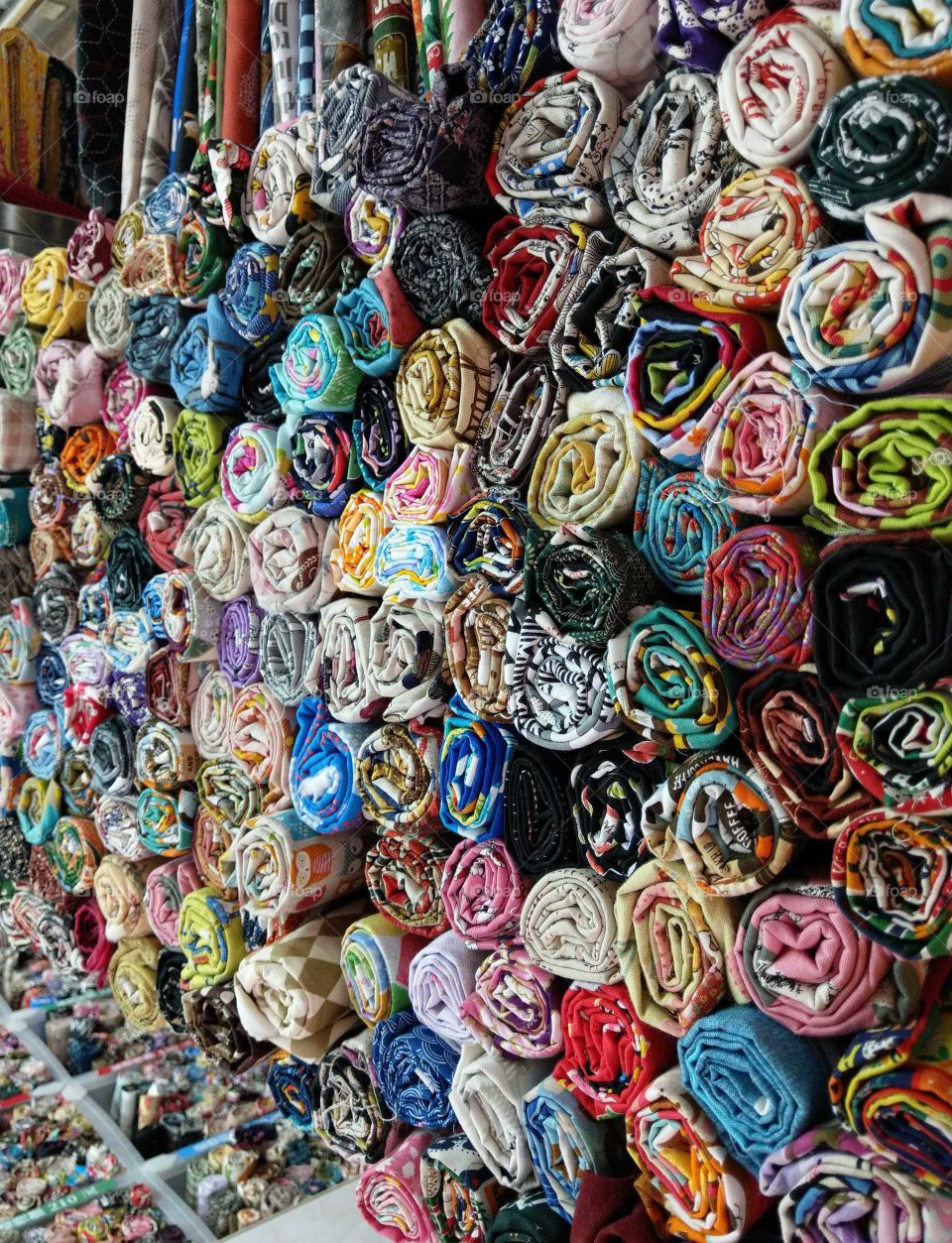 Various cloths in the traditional cloth store that roll up in cylindrical shape. they have various colors, so bright, beautiful and colorful. very special patterns.