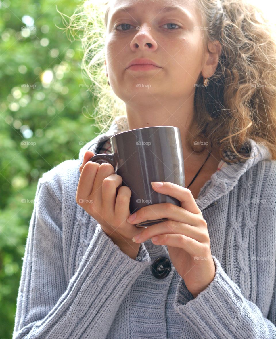 girl teenage looking with cup in hands beautiful portrait