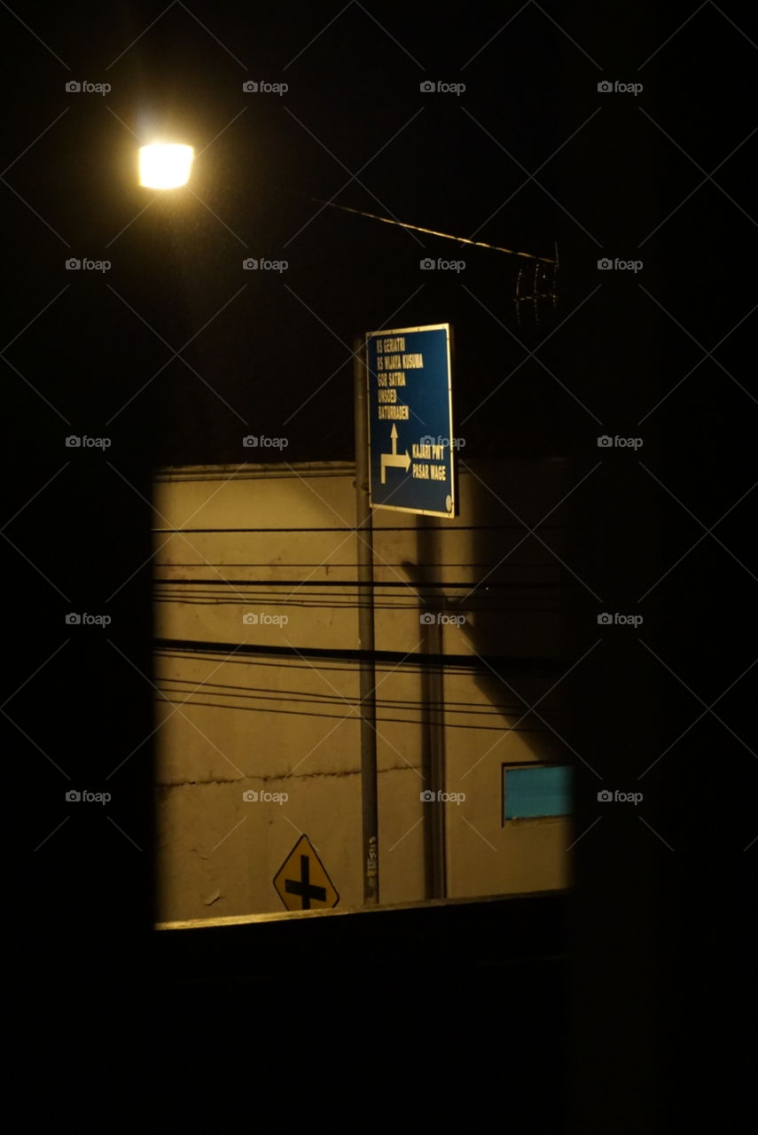 street sign from window view at night