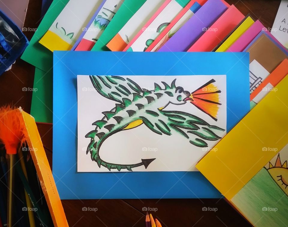 Color love dragon illustration along with other colorful pages and colored pencils
