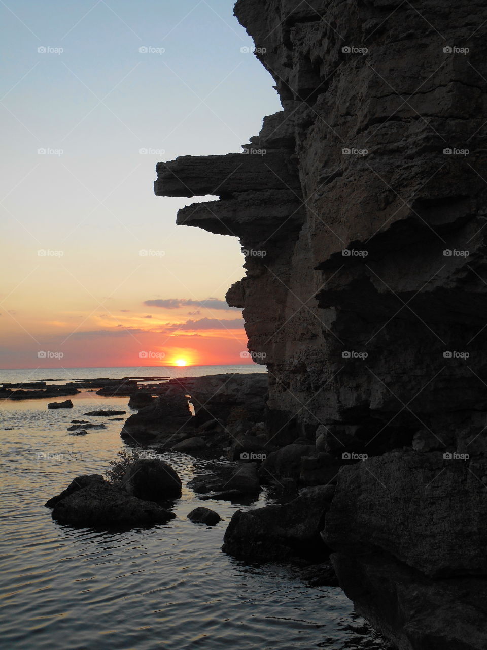 sunset on a sea shore and stones rocks art nature