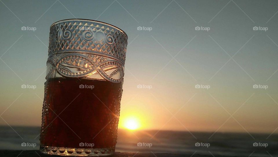 Beautiful cup of tea embraced a magic sunset.