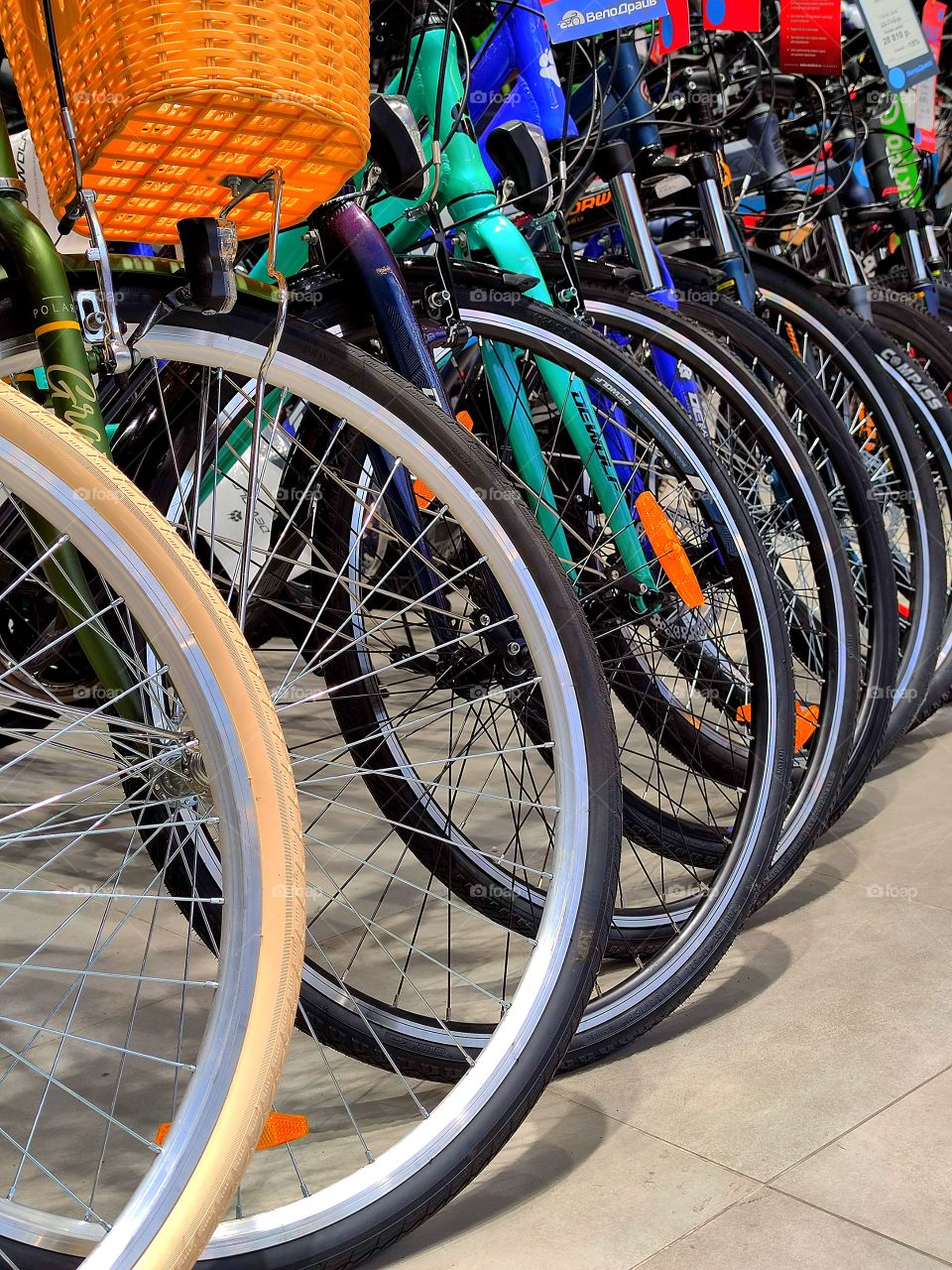 Bicycles in a row.  Front wheels of different bicycles
