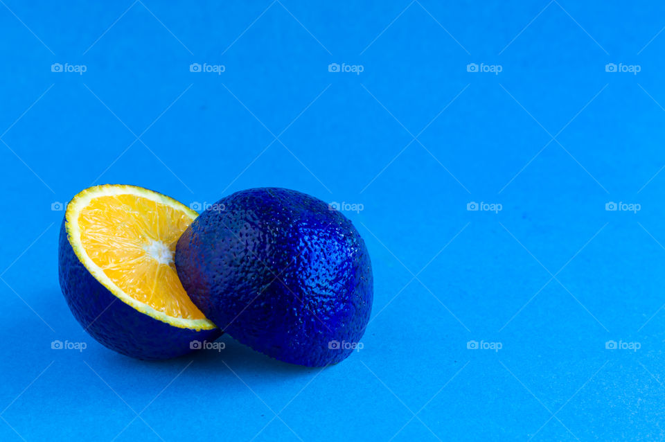 Orange painted blue isolated on light blue color background. Love these shades of blue and orange.