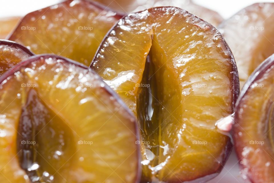 Slice of juicy delicious ripe plum.  macro photo,  fresh and frozen fruits concept.