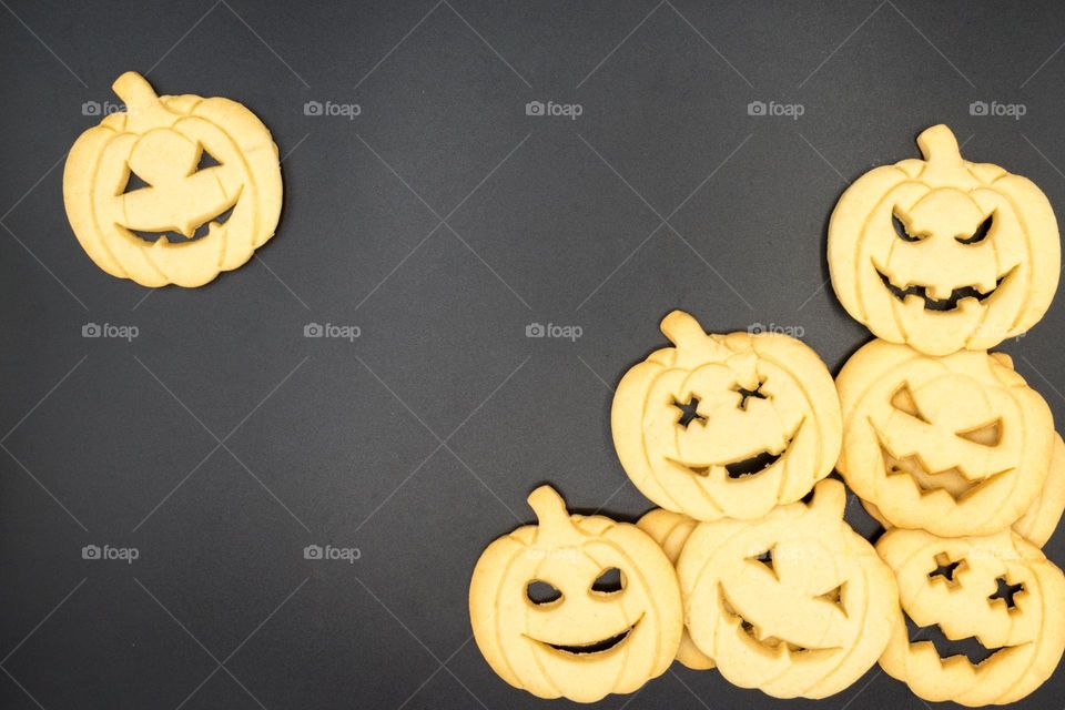 Halloween pumpkin-shaped cookies on a black background.