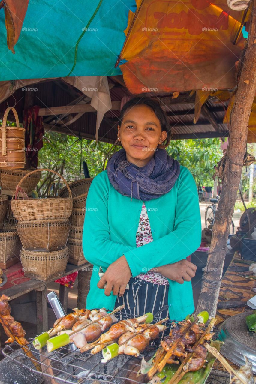 a Cambodian Woman sells grilled Frogs at a Street Food Stand in Siem Reap Cambodia Southeast Asia