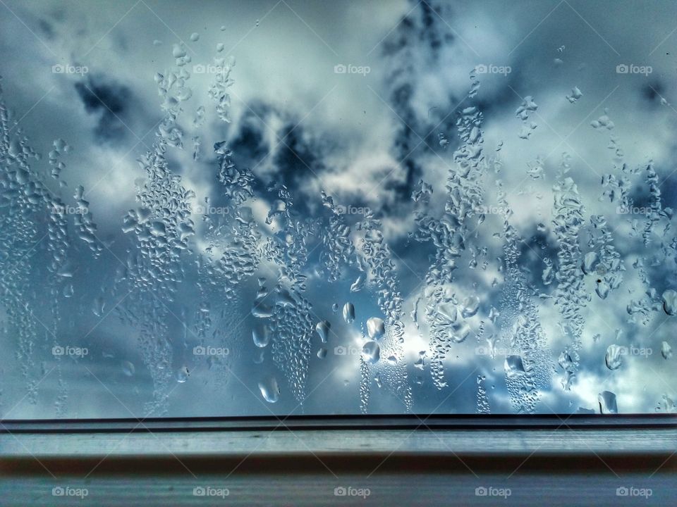 droplet on the window and blue sky background