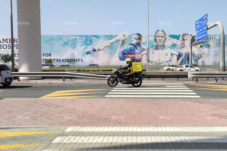 A Man Rides Motorcycle on City Road, Dubai