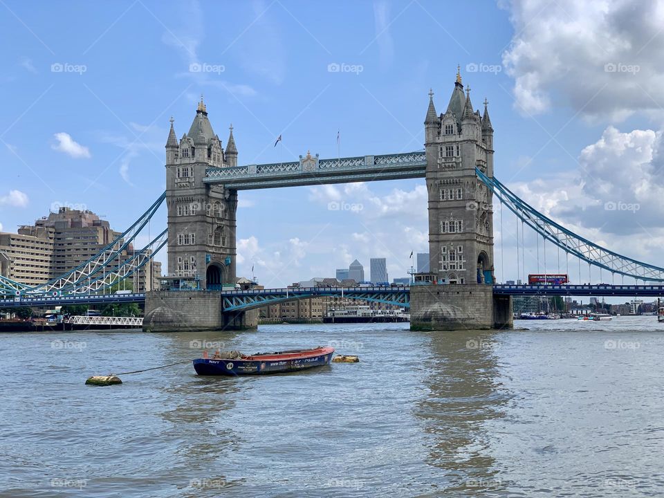 London’s bridge on a sunny day with view of Thames river and boats on a sunny day 