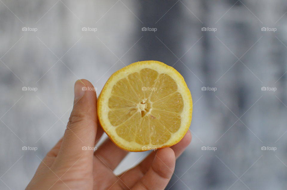 Close-up of a woman holding hand lemon