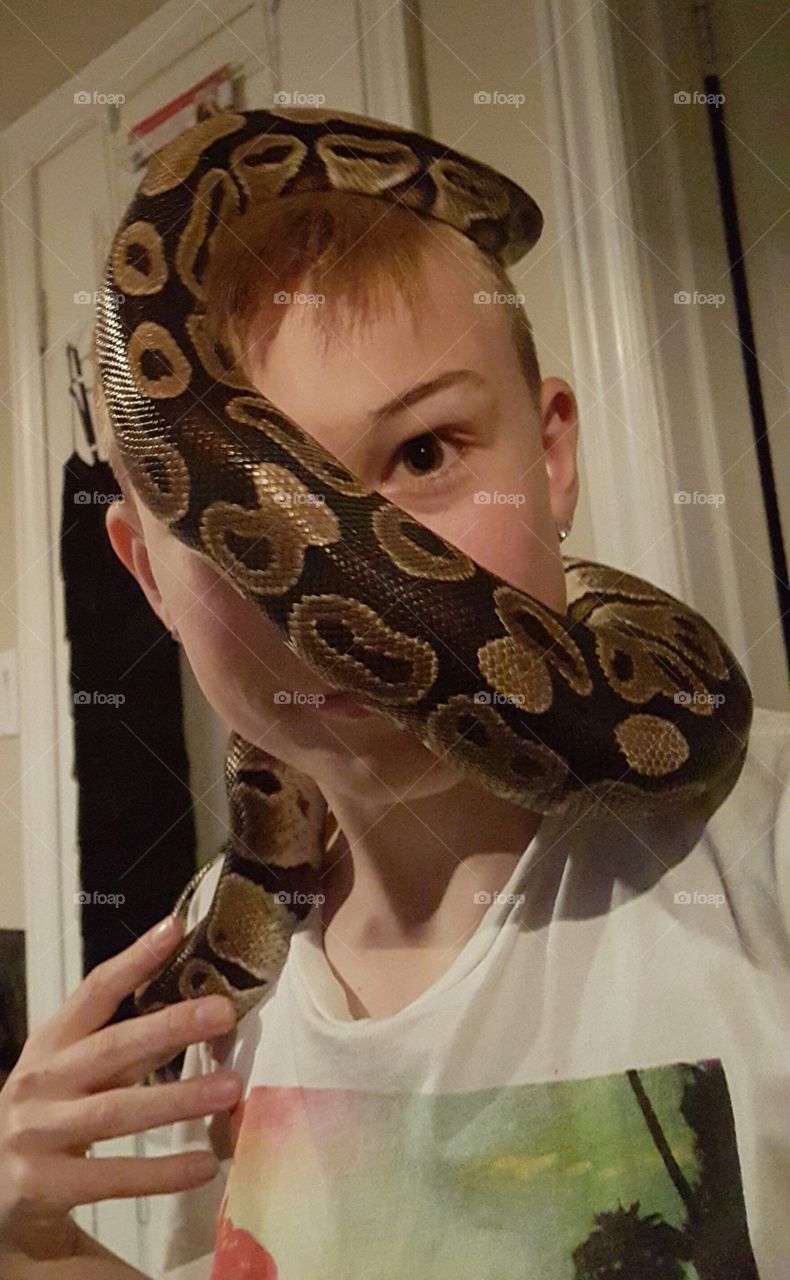 boy with snake wrapped around face