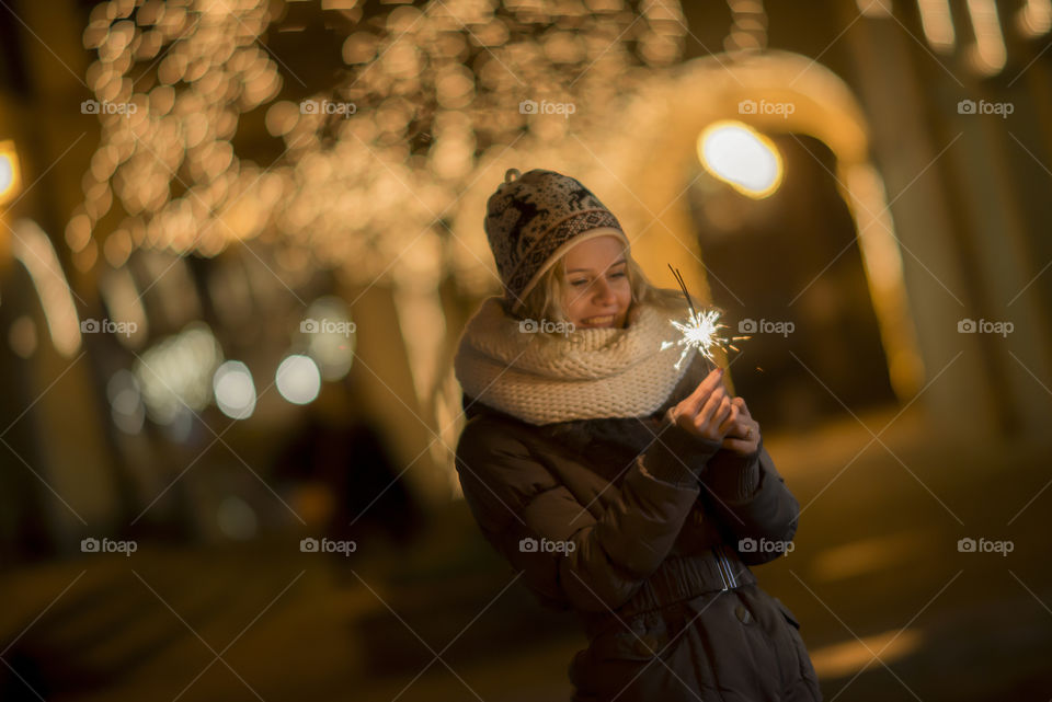 Young woman having fun with a sparkler