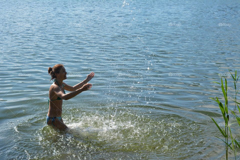 woman in swimsuit relaxing in water lake 💦 splash summer heat