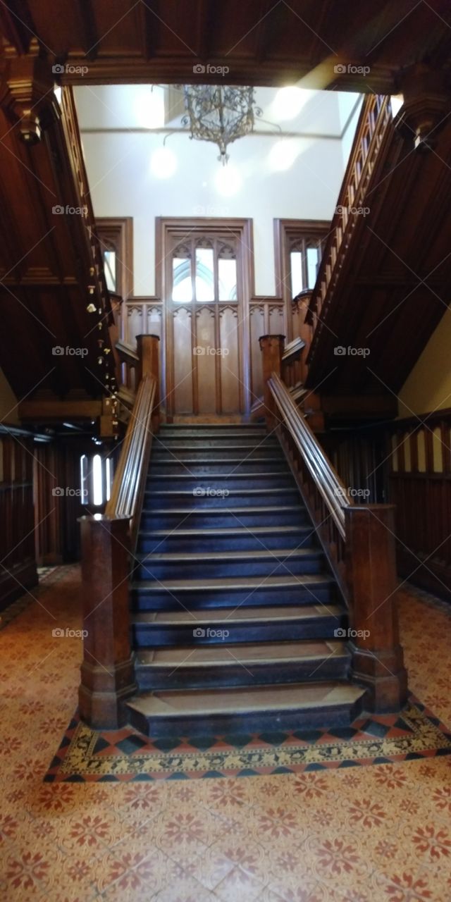 imposing wooden staircase in grand large house
