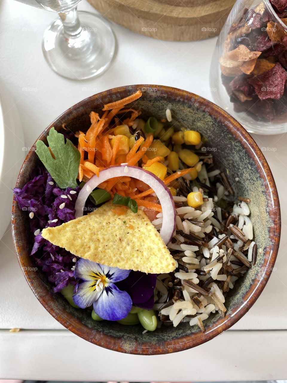 vegetarian salad with colorful vegetables and mixed rice, red cabbage, green beans, corn, carrots, cherry tomatoes, red onions,