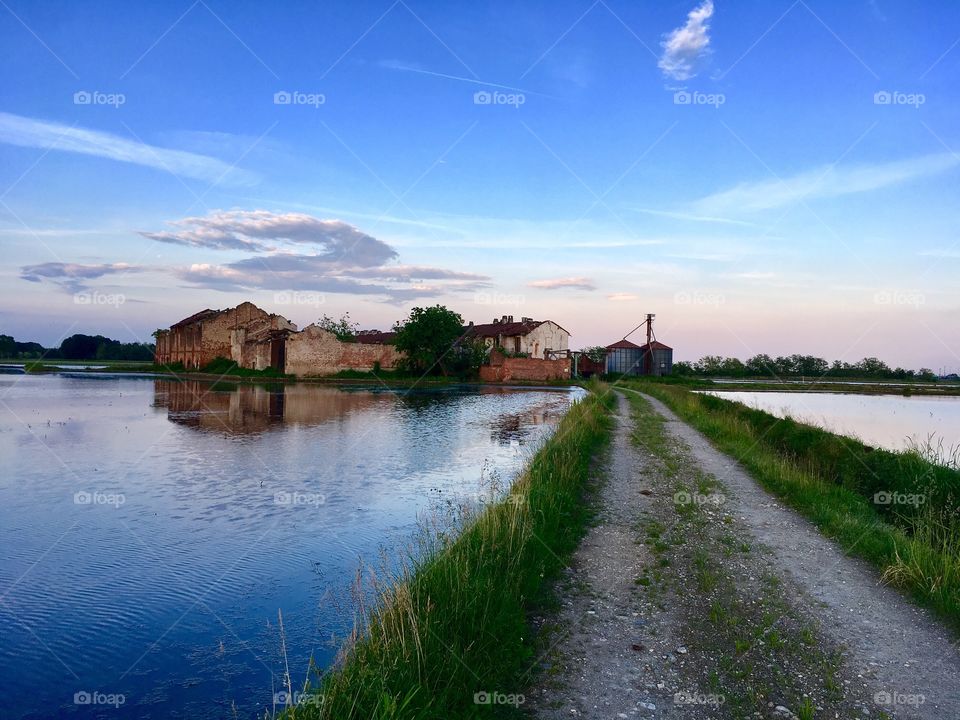 old abandoned farmhouse surrounded by rice fields, in the territory of Novara