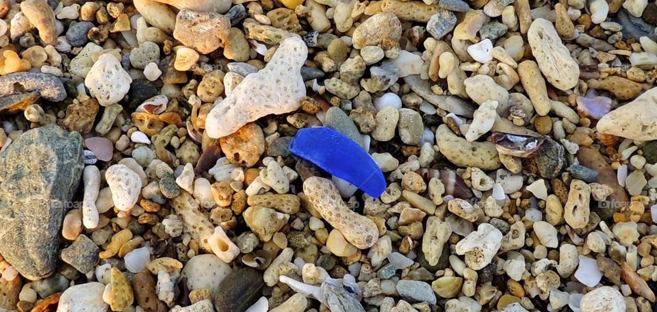 Blue Sea glass shimmer. Beach glass on the shores of an Okinawa beach