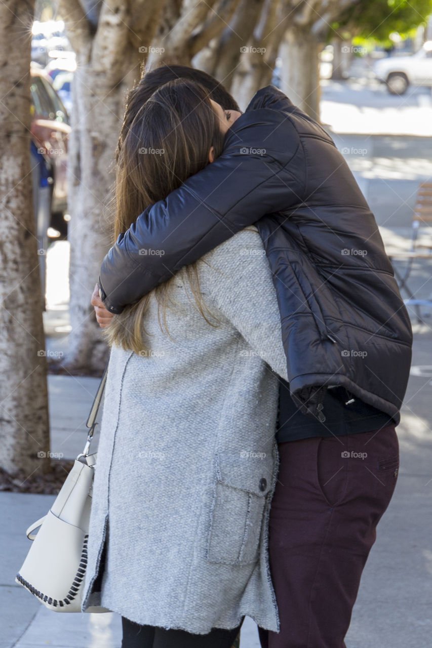 Young couple in love, hugging on street 