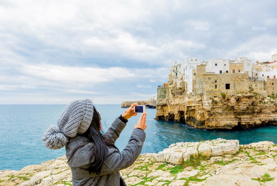 Woman taking photograph in mobile phone