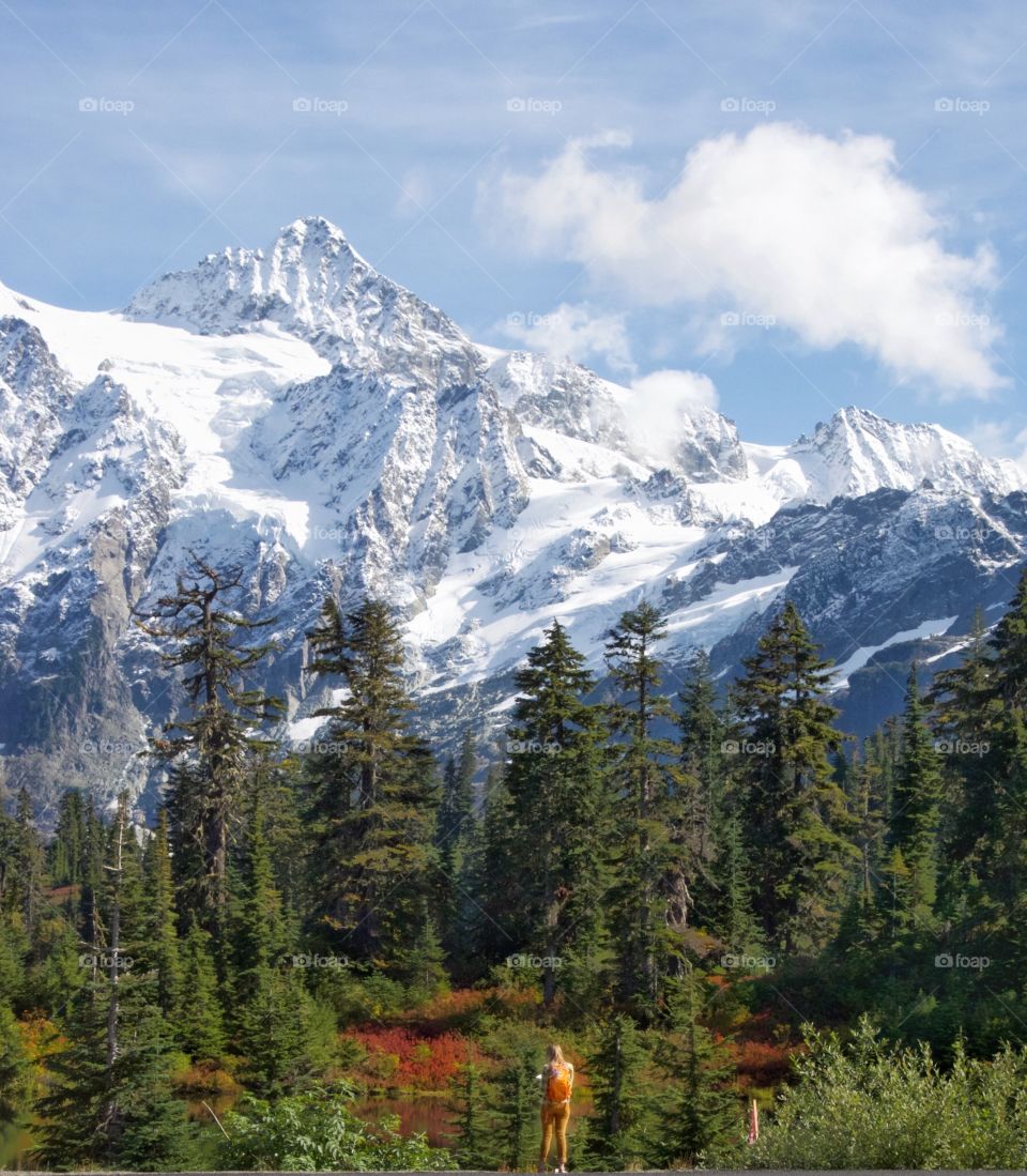 Woman standing in front of snow cover mountain