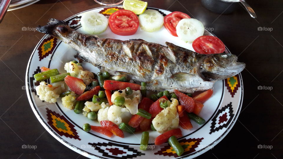 Fresh cooked fish with salad. A healthy way to satisfy your hunger