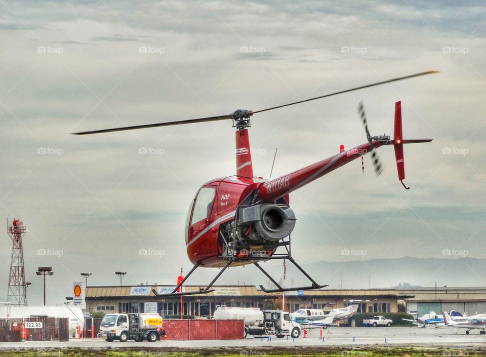 Helicopter Performing A Hover Taxi. Robinson R-22 Helicopter Preparing For Takeoff

