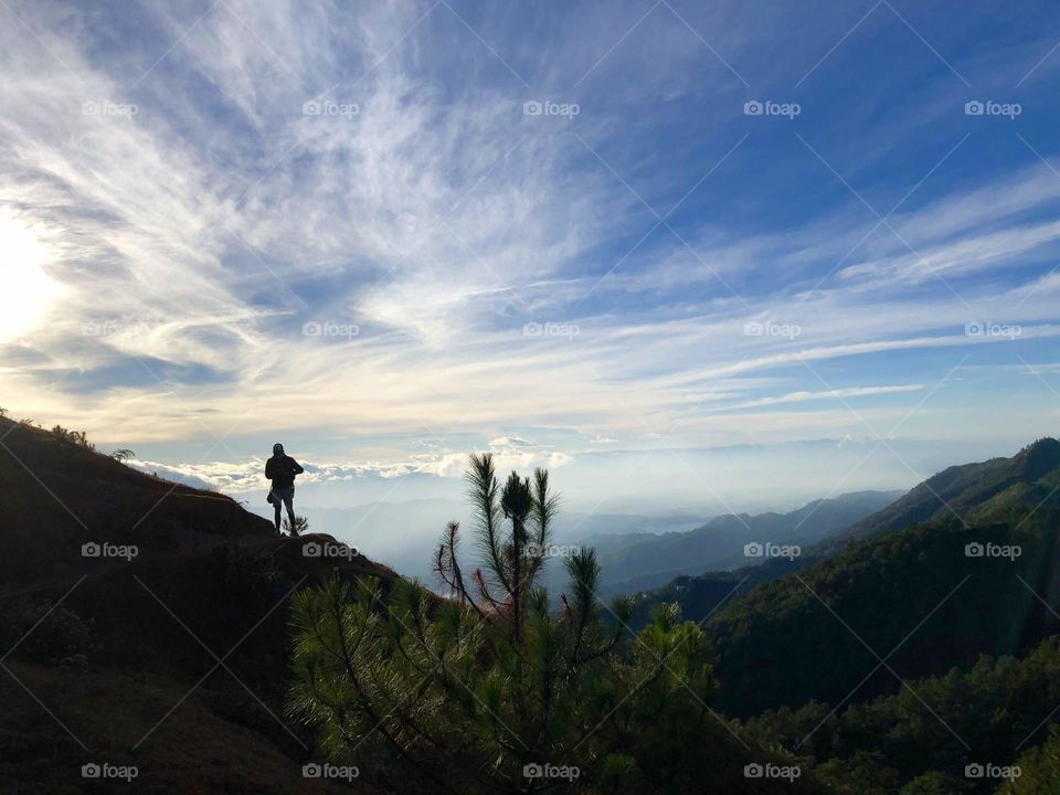 A man hiking during sunrise