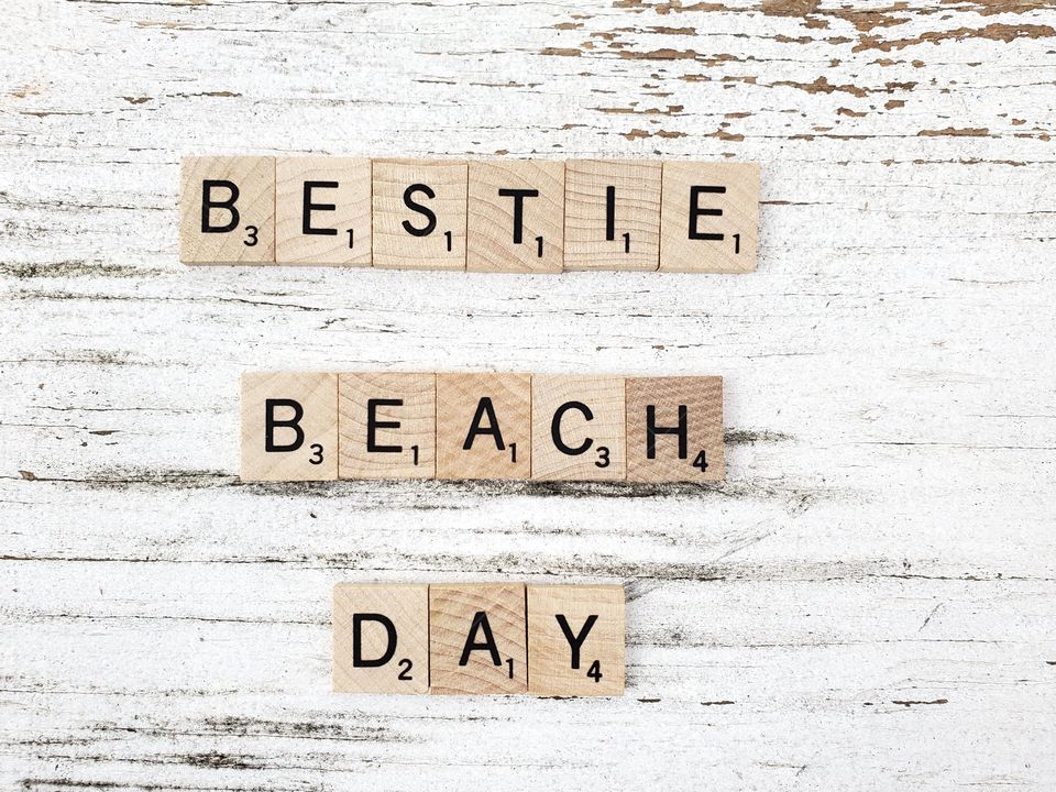 Best friends beach day wooden square word tiles on a rustic white background 