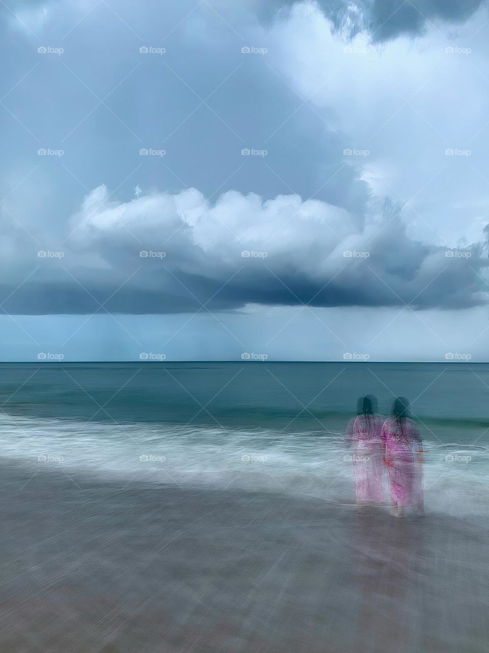 Atlantic Ocean Beach With Time In Motion Long Exposure Of The Waves  And A Child Watching The Storm On The Seashore During A Thunderstorm With Dark Grey Clouds.