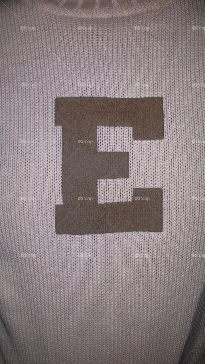 Brown letter E textile texture pink color