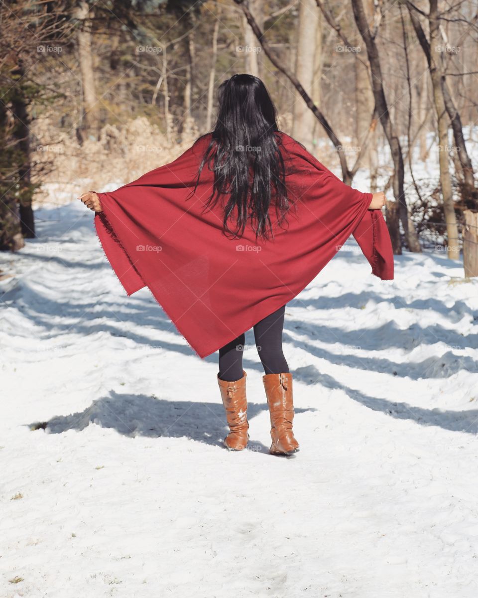 Shot of a stylish female with a gorgeous red shawl