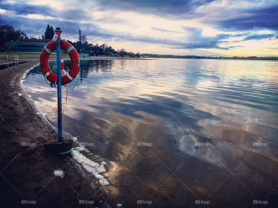 Moody skies over the beach and calm waters 