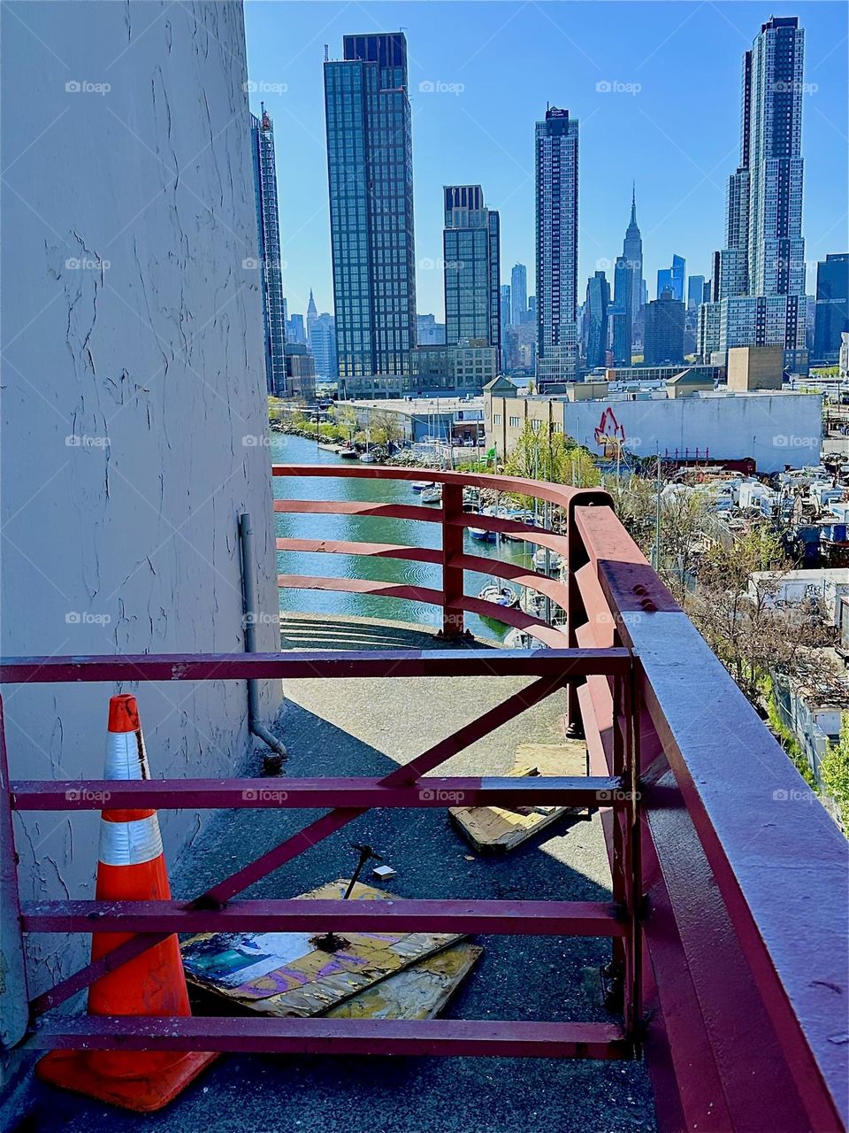 This is the center outpost of the “Pulaski Bridge” at “Newtown Creek” that connects LIC, Queens to “Greenpoint”, Brooklyn. Across the “East River” we see “Manhattan” including such landmarks as the “Empire State Building”. 2024. Hypnotic Productions