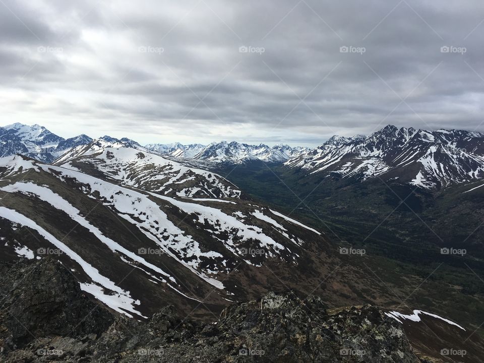 Mountain range against cloudy sky